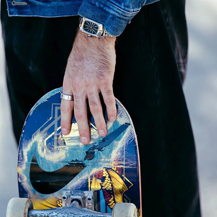 Man wearing the Nixon Frankie and holding his skateboard